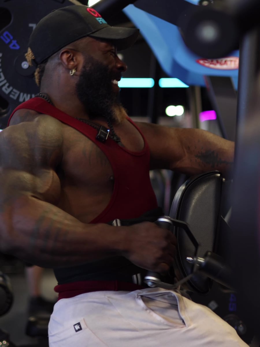 Athlete training his back in a dark gym